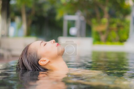 Photo for Portrait beautiful young asian woman relax smile around outdoor swimming pool in hotel resort on vacation travel - Royalty Free Image