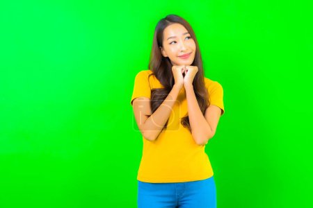 Photo for Portrait beautiful young asian woman smile with action on green isolated background - Royalty Free Image