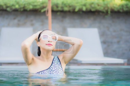 Photo for Portrait beautiful young asian woman relax smile leisure around outdoor swimming pool nearly sea beach in Travel vacation - Royalty Free Image