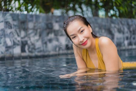 Photo for Portrait beautiful young asian woman relax leisure around swimming pool in hotel resort - Royalty Free Image
