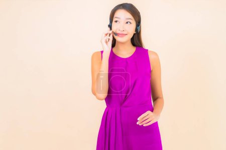 Photo for Portrait beautiful young asian woman with headset for call center customer on color background - Royalty Free Image