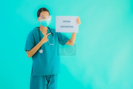 Photo for Portrait beautiful young asian doctor woman wear mask show Social distancing on paper board for protect from covid19 or coronavirus - Royalty Free Image