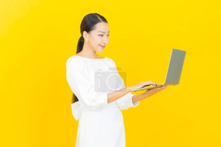 Photo for Portrait beautiful young asian woman smile with computer laptop on isolated background - Royalty Free Image
