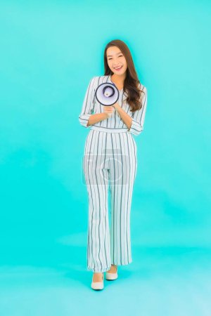 Photo for Portrait beautiful young asian woman use megaphone for communication on blue isolated background - Royalty Free Image