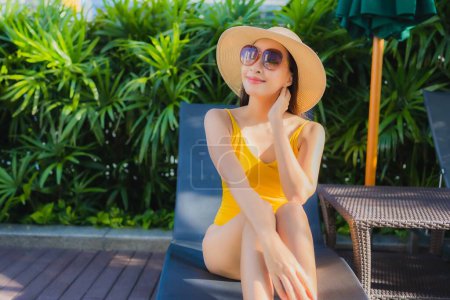 Photo for Portrait beautiful young asian woman relax happy smile around outdoor swimming pool in hotel resort for leisure vacation - Royalty Free Image