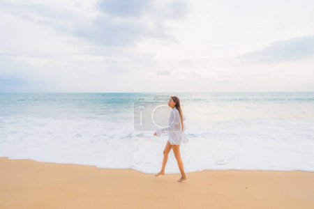 Téléchargez les photos : Portrait belle jeune femme asiatique se détendre loisirs autour de la plage en plein air océan de mer en vacances Voyage - en image libre de droit