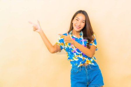 Téléchargez les photos : Portrait belle jeune femme asiatique porter chemise colorée pour festival songkran sur fond de couleur - en image libre de droit