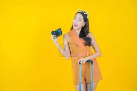 Photo for Portrait beautiful young asian woman use camera on color background - Royalty Free Image