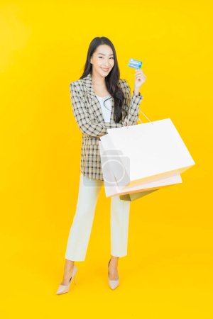 Photo for Portrait beautiful young asian woman smile with shopping bag on color background - Royalty Free Image