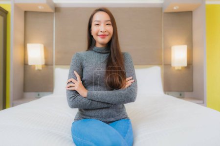 Photo for Portrait beautiful young asian woman relax smile leisure on bed in bedroom interior - Royalty Free Image
