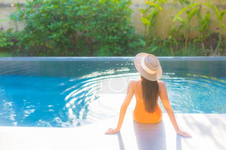 Photo for Portrait beautiful young asian woman enjoy relax around swimming pool for leisure vacation - Royalty Free Image