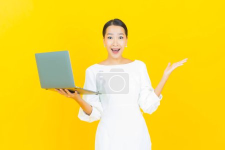 Photo for Portrait beautiful young asian woman smile with computer laptop on isolated background - Royalty Free Image