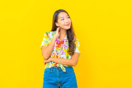 Photo for Portrait beautiful young asian woman wear colorful shirt on yellow background for sonkran festival in Thailand - Royalty Free Image