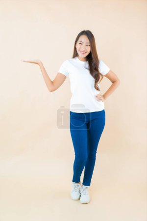 Photo for Portrait beautiful young asian woman smile with many action with cream color background - Royalty Free Image