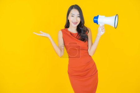 Photo for Portrait beautiful young asian woman smile with megaphone on color background - Royalty Free Image