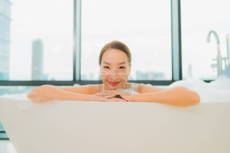 Photo for Portrait beautiful young asian woman relax smile leisure in bathtub in bathroom interior - Royalty Free Image