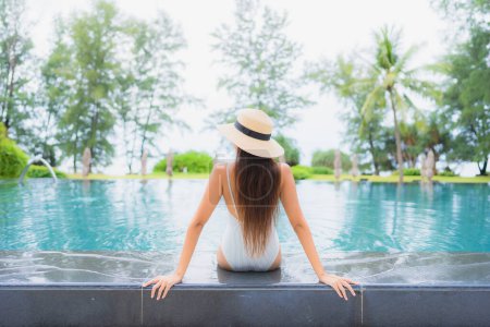 Photo for Portrait beautiful young asian woman relax smile leisure around outdoor swimming pool in hotel resort nearly sea beach - Royalty Free Image