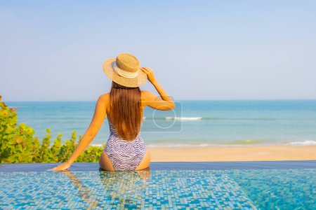 Photo for Portrait beautiful young asian woman relax smile enjoy leisure around swimming pool in resort hotel on vacation - Royalty Free Image