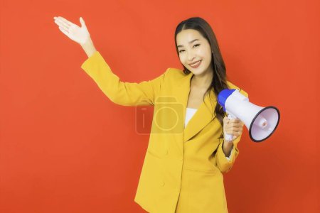 Photo for Portrait beautiful young business asian woman with megaphone for communication on red background - Royalty Free Image