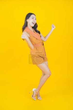 Photo for Portrait beautiful young asian woman smile with action on color background - Royalty Free Image