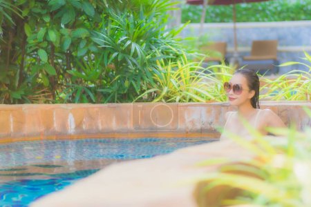 Photo for Portrait beautiful young asian woman relax around swimming pool in hotel resort for leisure in vacation - Royalty Free Image