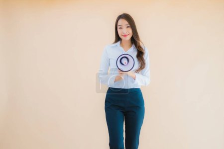 Photo for Portrait beautiful young asian business woman with megaphone for cummunication on isolated color background - Royalty Free Image