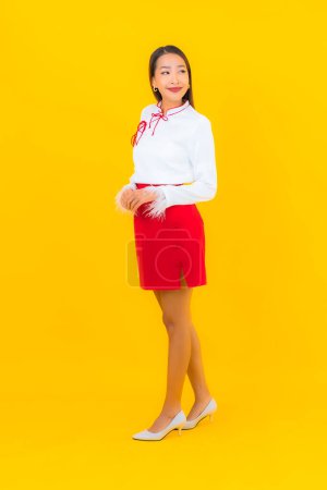 Photo for Portrait beautiful young asian woman smile in action on yellow background - Royalty Free Image
