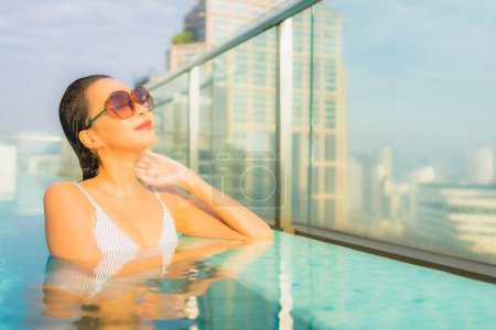 Photo for Portrait beautiful young asian woman relax leisure around outdoor swimming pool in hotel resort for travel vacation - Royalty Free Image