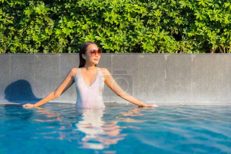 Photo for Portrait beautiful young asian woman relax smile leisure on vacation around swimming pool in resort hotel - Royalty Free Image