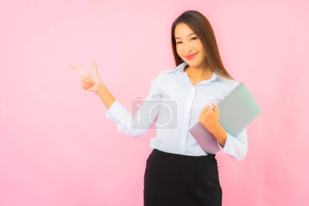 Photo for Portrait beautiful young asian woman with computer laptop on pink color background - Royalty Free Image