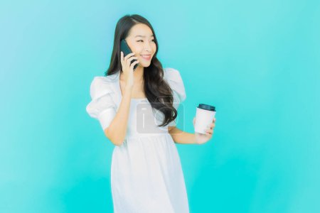 Photo for Portrait beautiful young asian woman smile with smart mobile phone on color background - Royalty Free Image