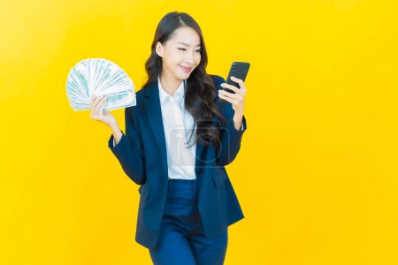 Photo for Portrait beautiful young asian woman smile with a lot of cash and money on color background - Royalty Free Image