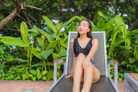 Photo for Portrait beautiful young asian woman leisure relax smile around outdoor swimming pool for vacation - Royalty Free Image