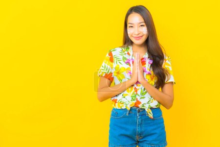 Photo for Portrait beautiful young asian woman wear colorful shirt with water gun for sonkran festival - Royalty Free Image