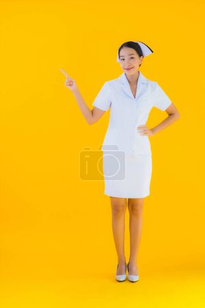 Photo for Portrait beautiful young asian thai nurse in many action work for patient in clinic and hospital on yellow isolated background - Royalty Free Image