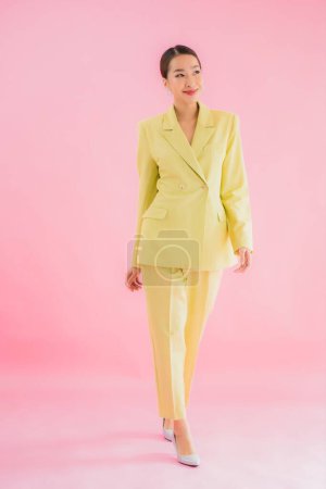 Photo for Portrait beautiful young asian business woman smile in action on pink color background - Royalty Free Image