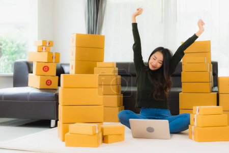Photo for Portrait beautiful young asian woman work at home and prepare cardboard box packaging ready for online shipping - Royalty Free Image