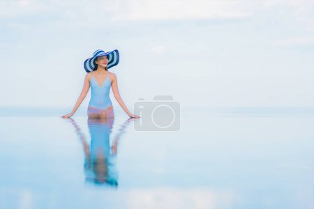 Photo for Portrait beautiful young asian woman relax smile around outdoor swimming pool in hotel resort nearly sea beach ocean - Royalty Free Image