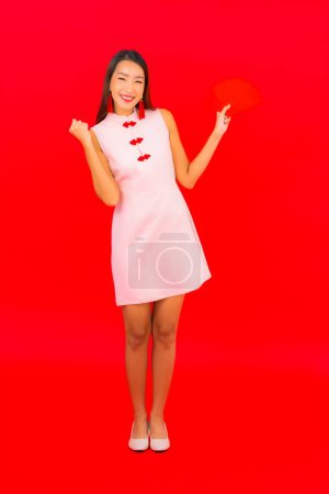 Photo for Portrait beautiful young asian woman with red envelope letter on red background - Royalty Free Image