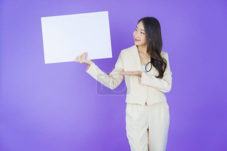 Photo for Portrait beautiful young asian woman with empty white billboard on color background - Royalty Free Image