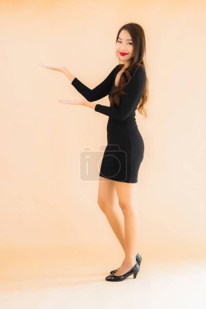 Photo for Portrait beautiful young asian woman happy smile in action on color isolated background - Royalty Free Image