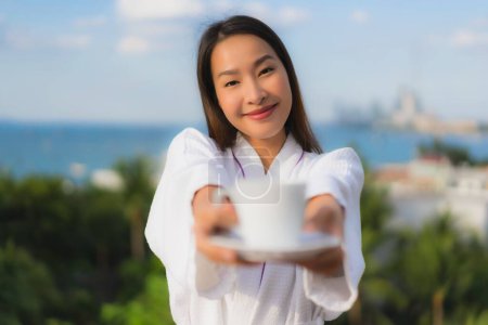Photo for Portrait beautiful young asian women hold coffee cup in hand around nature outdoor view - Royalty Free Image