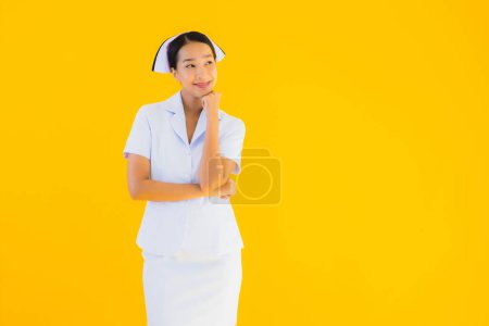 Photo for Portrait beautiful young asian thai nurse in many action work for patient in clinic and hospital on yellow isolated background - Royalty Free Image