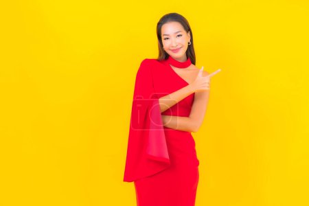 Photo for Portrait beautiful young asian woman smile with action on yellow isolated background - Royalty Free Image