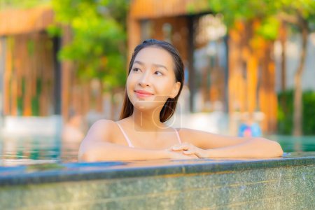 Photo for Portrait beautiful young asian woman relax smile enjoy leisure around swimming pool in hotel resort - Royalty Free Image