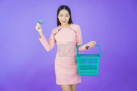 Photo for Portrait beautiful young asian woman smile with grocery basket from supermarket on color background - Royalty Free Image