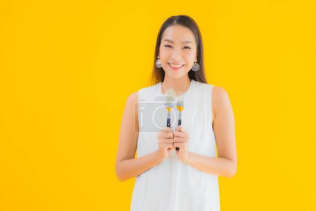 Photo for Portrait beautiful young asian woman with fork spoon on yellow isolated background - Royalty Free Image