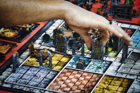 Photo for Close-up of someone's hand picking up a playing piece on the board of role-playing game Hero Quest - Royalty Free Image