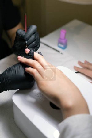 Photo for Close-up of woman 's hand with manicure in salon. professional nail service. - Royalty Free Image