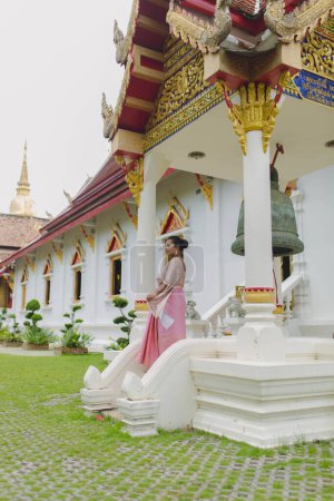 Girl in Wat Phra Singh Buddhist temple in Chiang Mai northern Thailand